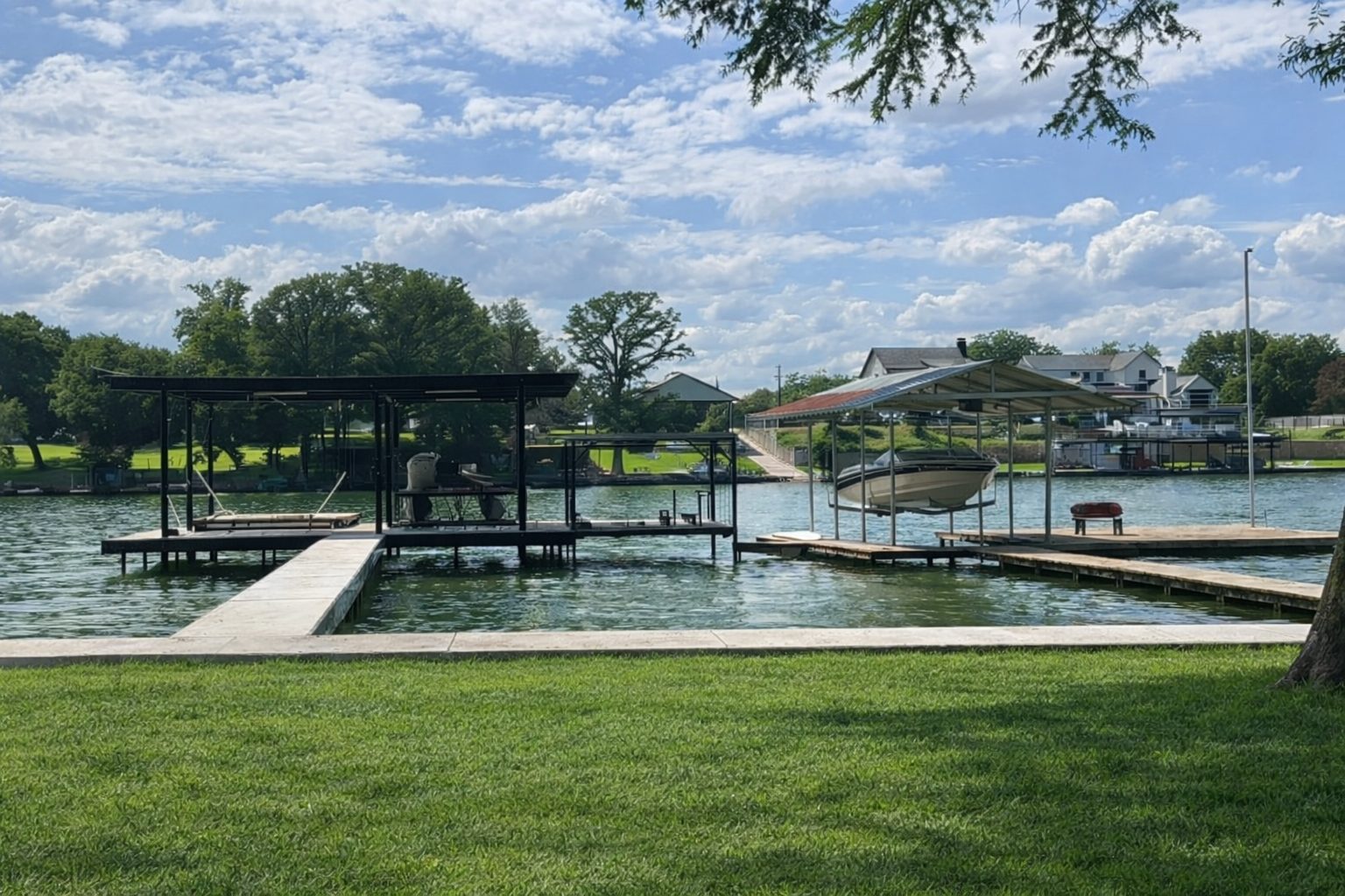 Double boathouse with boatlift, pier, and dock on Lake Dunlap by Waterfront Unlimited
