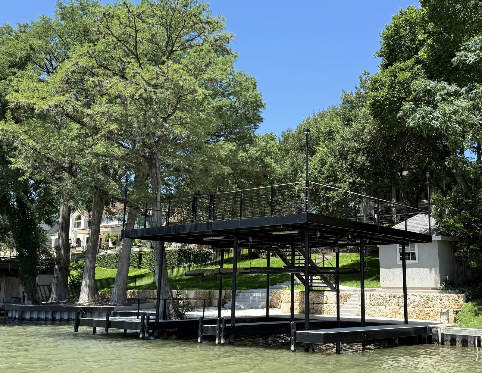 Boathouse, boatlift, bulkhead, and upper-level patio on Lake Dunlap by Waterfront Unlimited