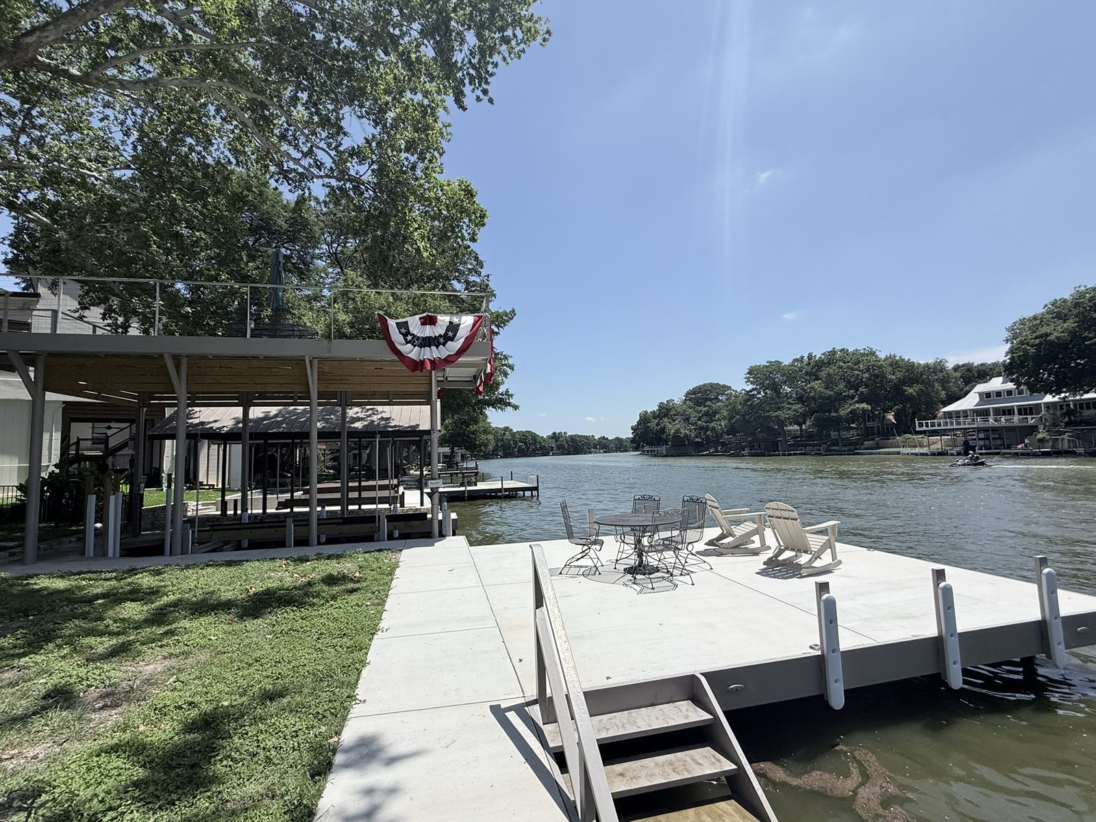 Full waterfront with CLOC vinyl bulkhead, boathouse, and upper-level patio on Lake McQueeney by Waterfront Unlimited