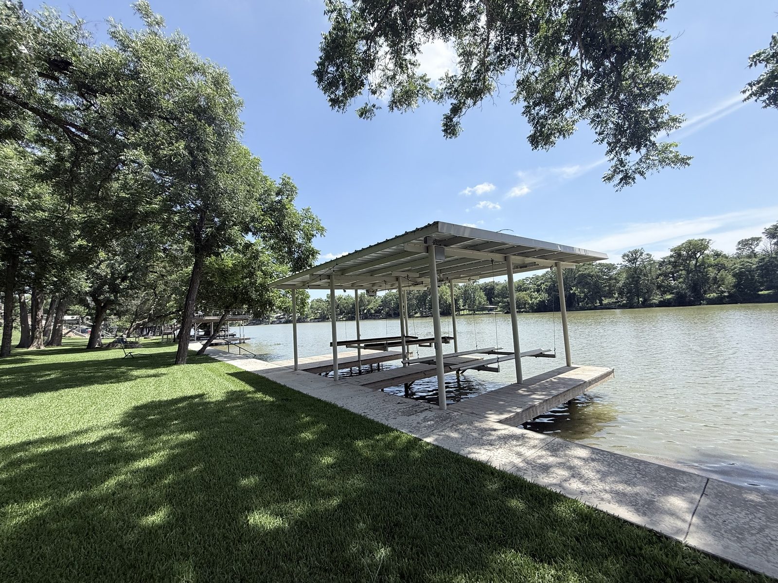Double boathouse with boatlift and dock on Lake Placid by Waterfront Unlimited